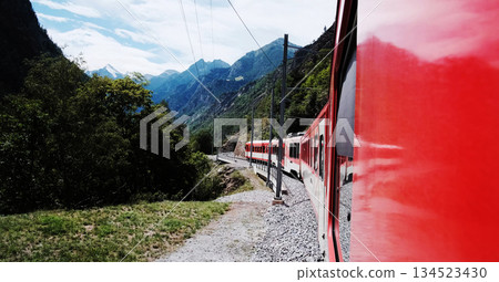 Red Train Going By Path Through The Mountains Red Train Going By Path Through The Mountains 134523430
