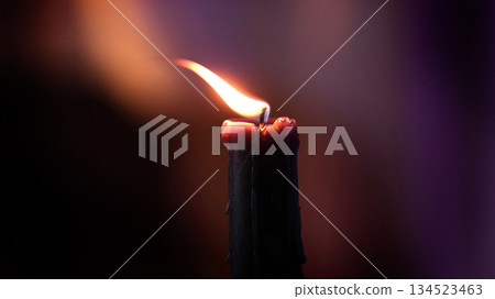 Lighting A Candle Against Blurred Background Lighting A Candle Against Blurred Background 134523463