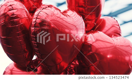 Tied Red Heart-Shaped Balloons 134523474