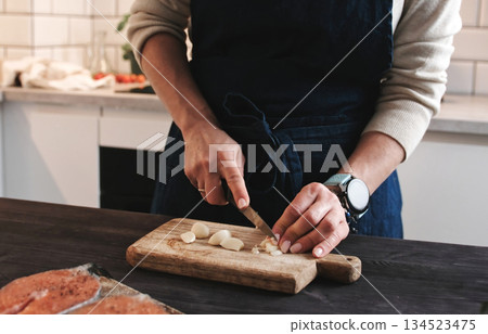 Woman Cutting A Garlic, Cooking Dinner In A Kitchen 134523475