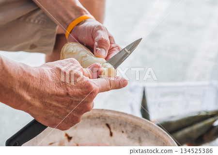 Farmer peeling bamboo shoot with knife in local market 134525386