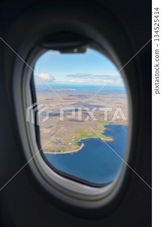 Scenic view of ocean and landscape through airplane window Scenic view of ocean and landscape through airplane window 134525414