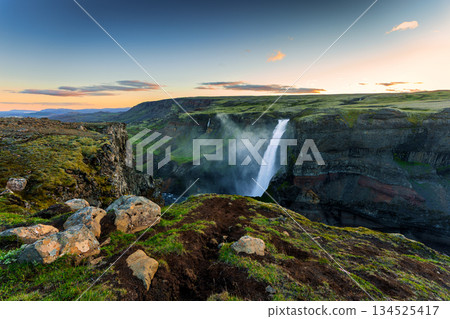 Scenic view of Haifoss waterfall and rugged canyon landscape during sunset in Icelandic Highlands 134525417