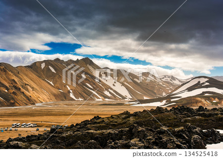 Scenic view of Landmannalaugar with volcanic mountain, black lava and clouds in Highlands of Iceland 134525418