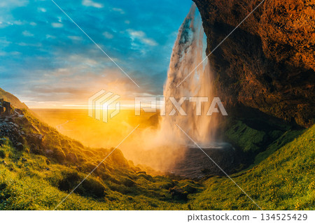 Beautiful sunset shining over Seljalandsfoss waterfall during summer in Iceland 134525429