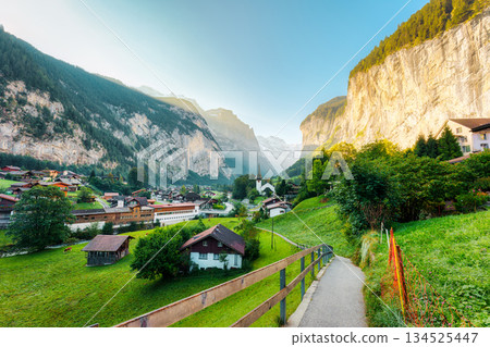 Rustic village in Lauterbrunnen valley with famous church and Staubbach Falls in the morning at Switzerland 134525447