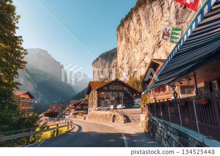 Picturesque rustic Swiss village of Lauterbrunnen valley and Staubbach falls at Canton of Bern, Switzerland 134525448