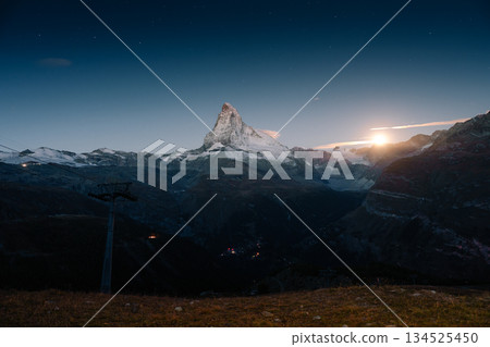 Matterhorn mountain with moonlight glowing in the dusk at Switzerland Matterhorn mountain with moonlight glowing in the dusk at Switzerland 134525450
