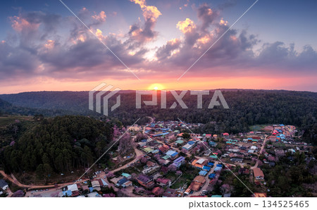Colorful sunset over rural village with wild himalayan cherry blooming in countryside at Ban Rong Kla Colorful sunset over rural village with wild himalayan cherry blooming in countryside at Ban Rong Kla 134525465