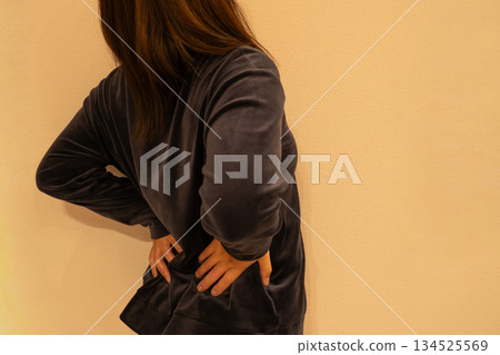 woman holding her waist woman holding her waist 134525569