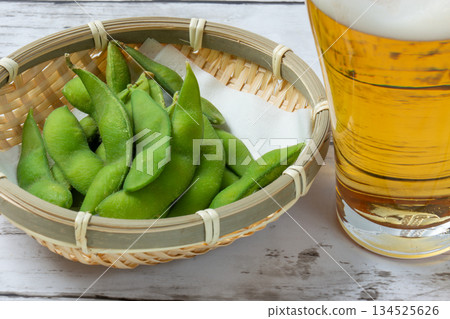 Beer and edamame beans on a white table 134525626