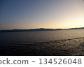 Silhouettes of the sea and mountains at dusk - a landscape that gives a sense of tranquility 134526048