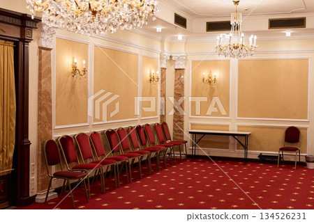 An Unused Opulent Ballroom Featuring Arranged Seating And Shimmering Chandeliers Awaiting Guests An Unused Opulent Ballroom Featuring Arranged Seating And Shimmering Chandeliers Awaiting Guests 134526231