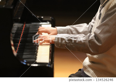 A boy playing the piano A boy playing the piano 134526246