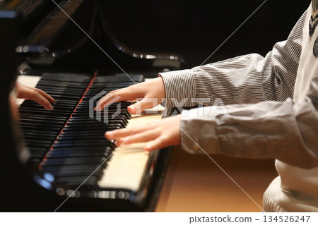 A boy playing the piano A boy playing the piano 134526247