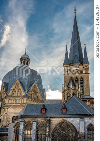Aachen Cathedral domes and spire under dramatic winter clouds 134526307