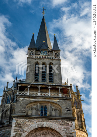 Aachen Cathedral clock tower and spires under dramatic clouds Aachen Cathedral clock tower and spires under dramatic clouds 134526311