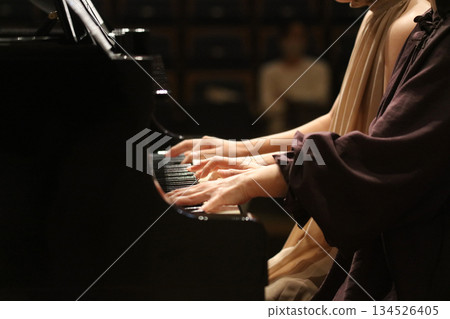 A woman playing the piano 134526405