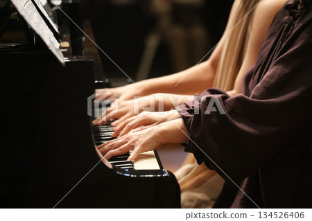 A woman playing the piano 134526406