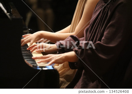 A woman playing the piano 134526408