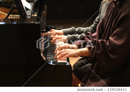 A woman playing the piano 134526411