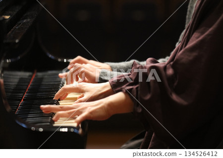 A woman playing the piano 134526412