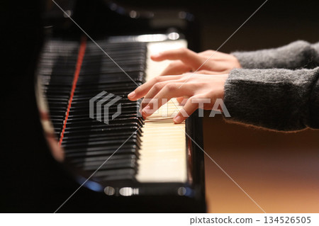 A woman playing the piano 134526505