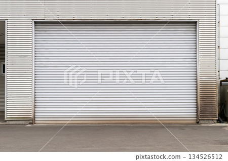 A closeup shot of automatic metal roller door used in factory, storage, garage, and industrial warehouse. The corrugated and foldable metal sheet offer space saving and provide urban and rustic feel 134526512