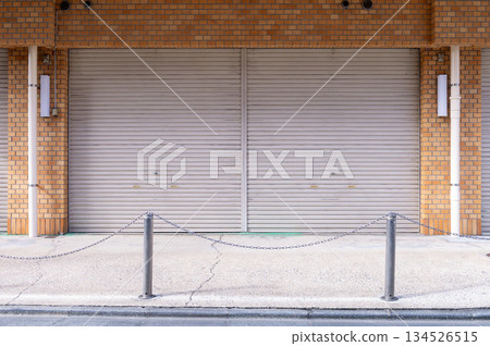 A closeup shot of automatic metal roller door used in factory, storage, garage, and industrial warehouse. The corrugated and foldable metal sheet offer space saving and provide urban and rustic feel 134526515