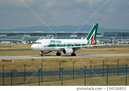 Frankfurt, Germany, July 09 2017: Italian Airbus A320 Taxiing Past Spotting Point Toward Runway Frankfurt, Germany, July 09 2017: Italian Airbus A320 Taxiing Past Spotting Point Toward Runway 134526933