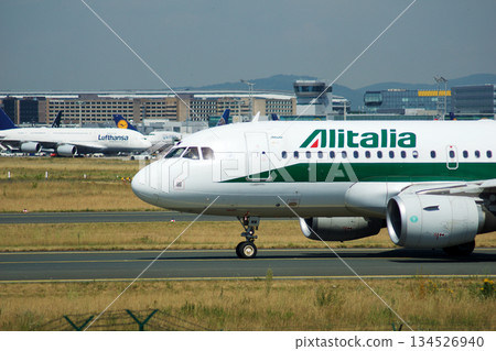 Frankfurt, Germany, July 09 2017: Italian Airbus A320 Taxiing Past Spotting Point Toward Runway Frankfurt, Germany, July 09 2017: Italian Airbus A320 Taxiing Past Spotting Point Toward Runway 134526940