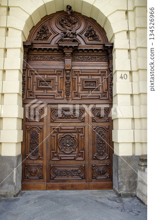 Turin, Italy, September 14, 2019: Ornate Wooden Entrance Door of Historic Building in City Center Turin, Italy, September 14, 2019: Ornate Wooden Entrance Door of Historic Building in City Center 134526966