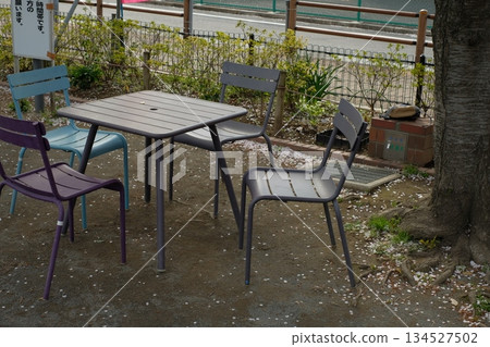 Tables and chairs set up in an outdoor park 134527502