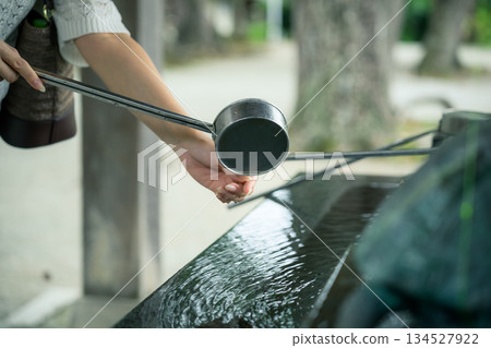 一位女子在神社的茶水屋使用湯匙。 134527922