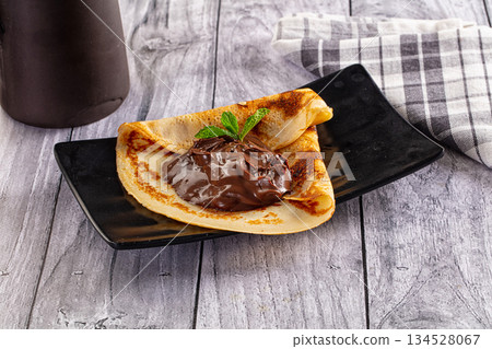 Sweet pancake with chocolate paste Sweet pancake with chocolate paste 134528067