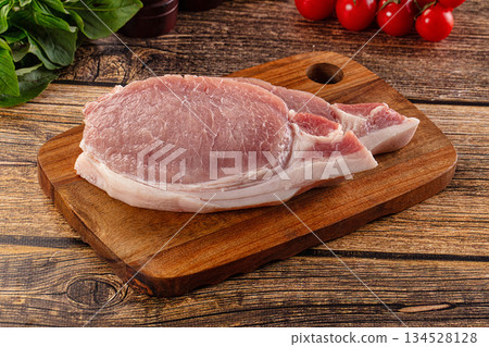 Raw pork steak over board Raw pork steak over board 134528128