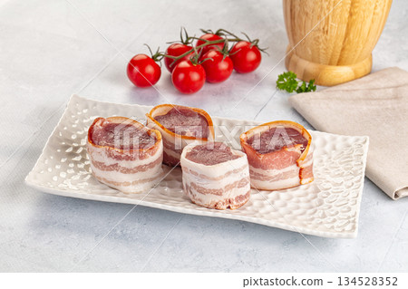 Raw pork tenferloin with bacon 134528352