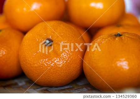 Freshly picked, delicious golden tangerines piled together Freshly picked, delicious golden tangerines piled together 134529360