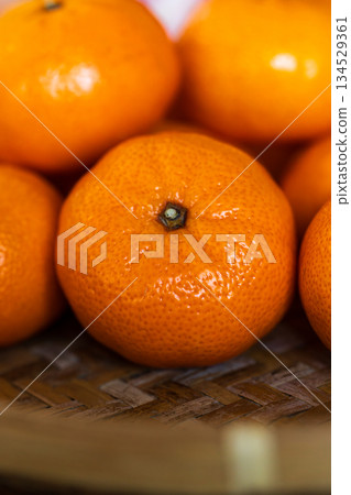 Freshly picked, delicious golden tangerines piled together Freshly picked, delicious golden tangerines piled together 134529361