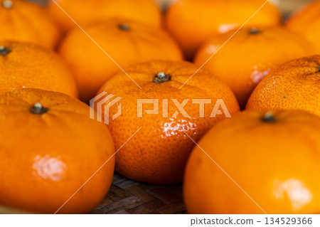 Freshly picked, delicious golden tangerines piled together Freshly picked, delicious golden tangerines piled together 134529366