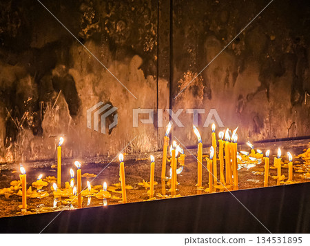 Burning Church Candles in Metal Holder Burning Church Candles in Metal Holder 134531895