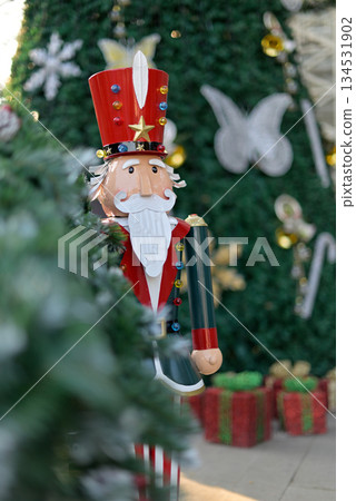 Festive Nutcracker Soldier by Christmas Tree Festive Nutcracker Soldier by Christmas Tree 134531902