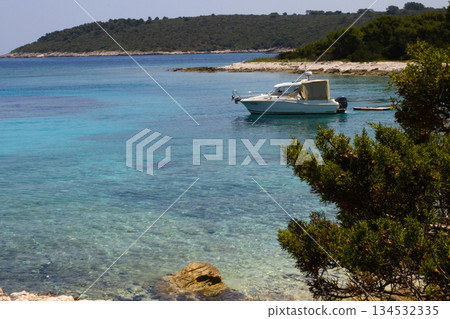 Boat anchoring in a bay on Proizd island, Croatia. Expotic destinations. Summer travel Boat anchoring in a bay on Proizd island, Croatia. Expotic destinations. Summer travel 134532335