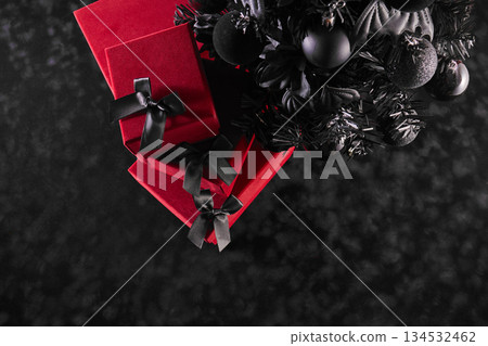 Holiday Elegance. Red gifts with black bows under a black Christmas tree 134532462