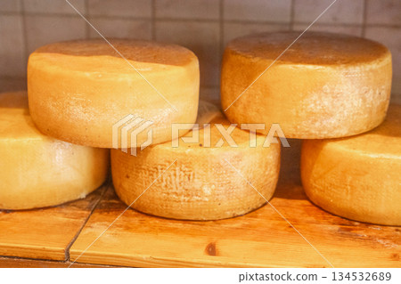 Close-up of cheese wheels displayed in shop. Natural food texture and gourmet concept 134532689