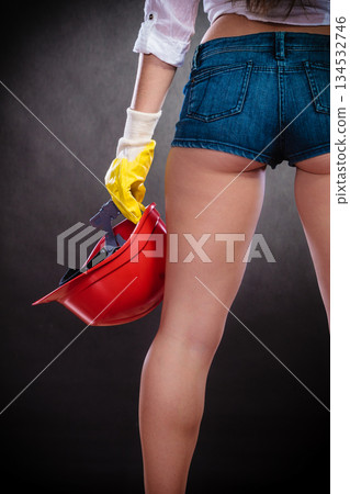 Feminist woman back with helmet. 134532746