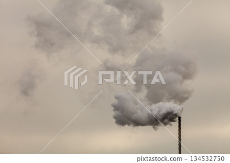 Smoke from chimney on dark cloudy sky 134532750