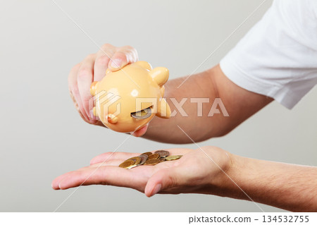 Male hands with coins and piggybank Male hands with coins and piggybank 134532755
