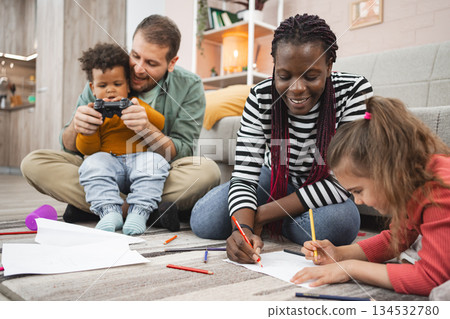 Multiracial family enjoys creative activities at home 134532780
