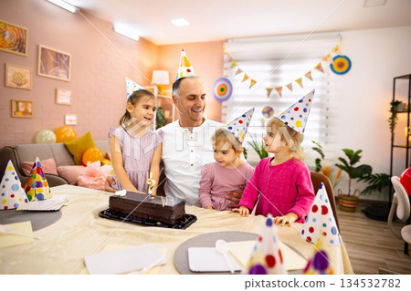 Happy birthday in a cozy living room with kids and dad 134532782